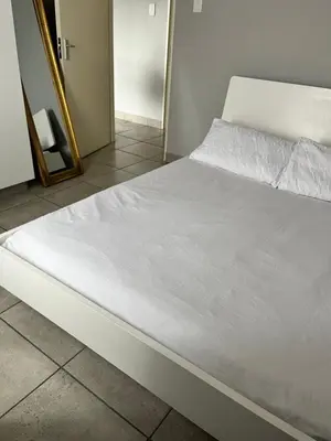a white bed in a room with a mirror at Wotela in Chartwell