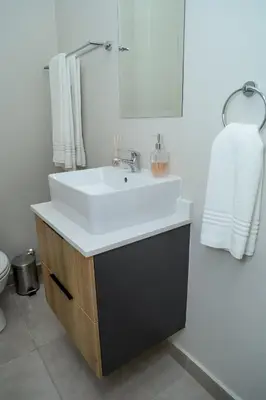 a bathroom with a white sink and a toilet at Real Kee in Midrand