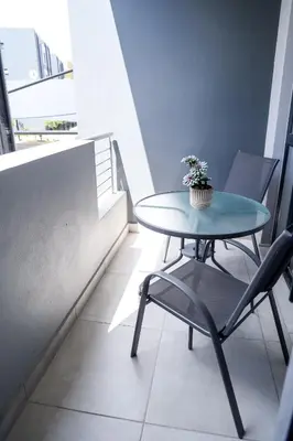 a table and chairs in a room with a window at Real Kee in Midrand
