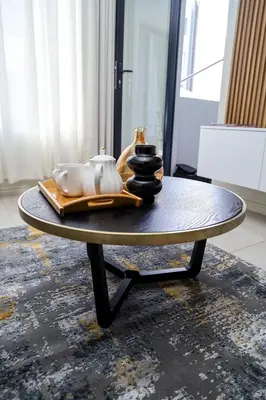 a coffee table with a tray and vases on it at Real Kee in Midrand