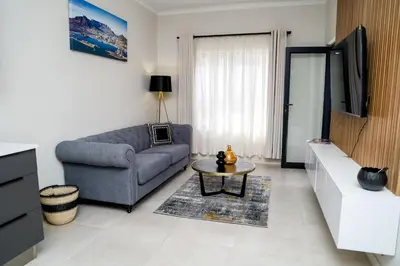 a living room with a couch and a table at Real Kee in Midrand