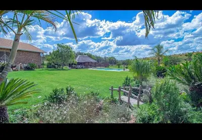 a yard with a house and a swimming pool at Elysium Falls House in Roodeplaat
