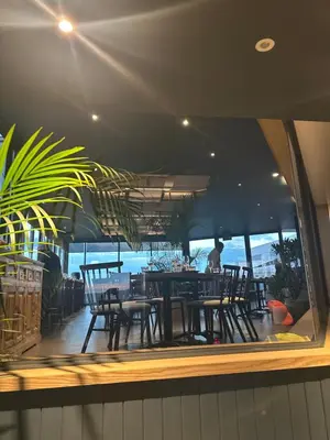 a reflection of a table and chairs in a window at Delarose business leisure Studio in Pretoria