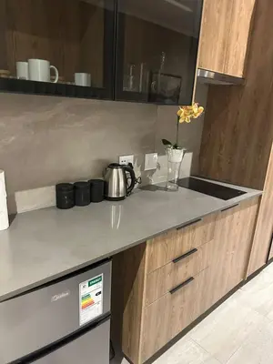 a kitchen counter with a tea kettle on it at Delarose business leisure Studio in Pretoria