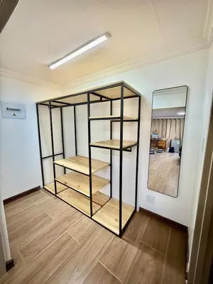 a room with a book shelf and a mirror at Austin Manor in Midrand