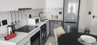 a kitchen with a table and a microwave at The Blyde Crystal Lagoon in Pretoria