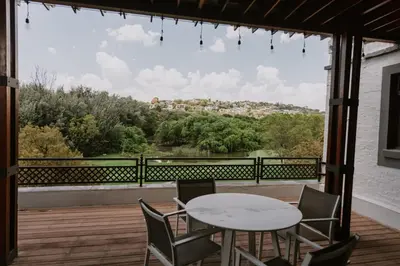 a patio with a table and chairs and a view at The Villa Palms in Pretoria
