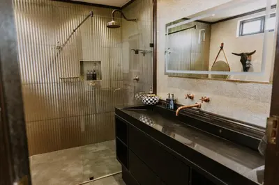 a bathroom with a sink and a mirror at The Villa Palms in Pretoria