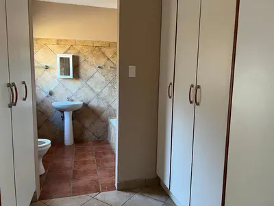 a bathroom with a toilet and a sink at Royal Apartments in Burgersfort