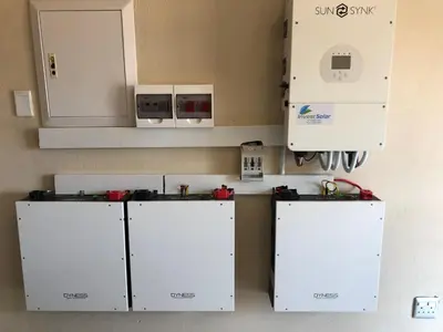 a small kitchen with white cabinets and appliances at Horizon small holding in Polokwane