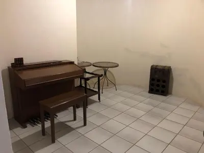a room with a piano and a small table at Horizon small holding in Polokwane