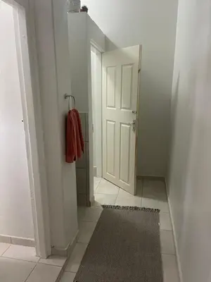 a hallway with a white door and a rug at Lani Accommodation in Pretoria