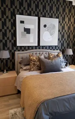 a bedroom with a bed and two tables with lamps at Luxury 7th Floor Menlyn Maine Residences in Pretoria