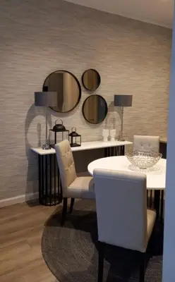a dining room with a table and two mirrors at Luxury 7th Floor Menlyn Maine Residences in Pretoria