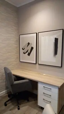 a desk with a chair and two pictures on the wall at Luxury 7th Floor Menlyn Maine Residences in Pretoria