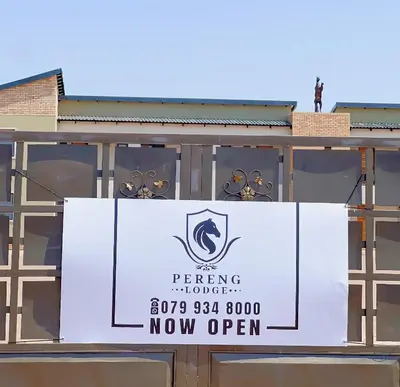 a banner is hanging on the side of a building at Pereng Lodge in Ga-Moloi