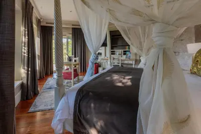 a bedroom with a bed with a canopy at The 506 Hotel in Midrand
