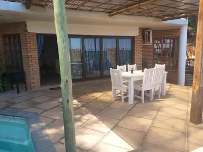 a white table and chairs on a patio at Sunset Cottage - Own Water - Own Electricity in Pretoria