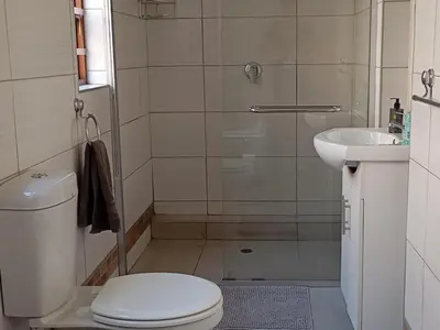 a bathroom with a toilet and a sink at Sunset Cottage - Own Water - Own Electricity in Pretoria