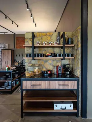 a kitchen with a counter and a stone wall at vanDijksRus Farm in The Waterberg Biosphere