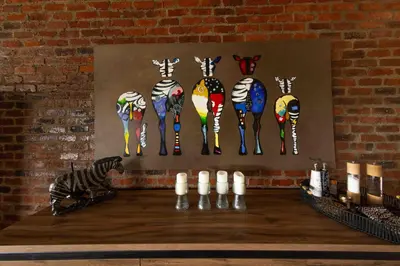 a painting of zebras and a zebra on a wall at vanDijksRus Farm in The Waterberg Biosphere