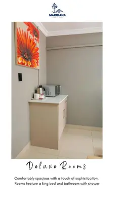 a kitchen with a counter and a painting on the wall at Marikana guest house