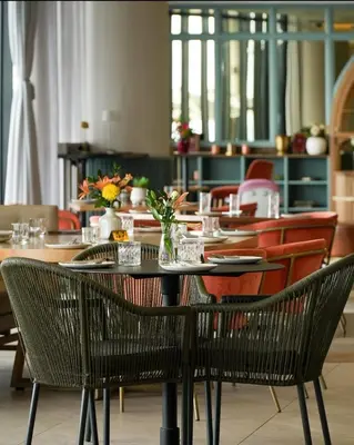 a dining room with a table and chairs at Mphoentle Residence ellipse waterfall in Midrand