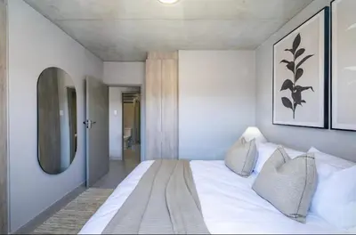 a bedroom with a white bed and a mirror at Elegant escape in Midrand in Midrand