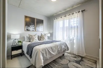 a bedroom with a large bed and a window at Elegant escape in Midrand in Midrand