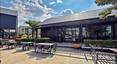 a patio with tables and chairs in front of a building at Elegant escape in Midrand in Midrand