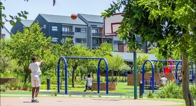 a man is playing basketball on a playground at Elegant escape in Midrand in Midrand