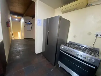 a kitchen with a stove and a refrigerator at Mbobo Legacy Residence in Pretoria