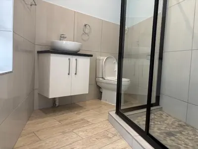 a bathroom with a sink and a toilet at The Manzi Villa in Hartbeespoort