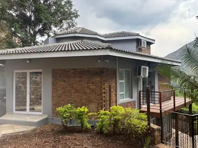 a house with a porch and a balcony at The Manzi Villa in Hartbeespoort