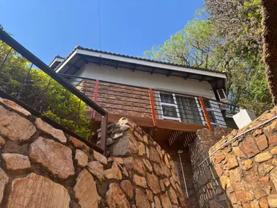 a house on top of a stone wall at The Manzi Villa in Hartbeespoort