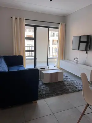 a living room with a couch and a tv at Crystal ace lagoon in Midrand