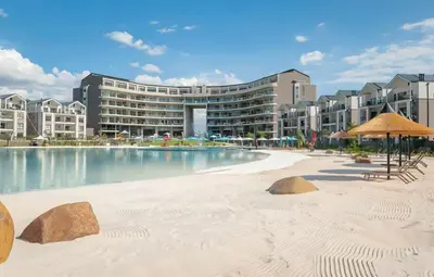 a resort with a sandy beach and a building at Crystal ace lagoon in Midrand