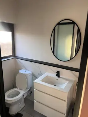 a bathroom with a toilet and a sink and a mirror at Crystal ace lagoon in Midrand