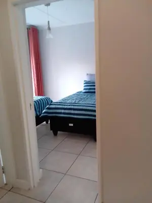 a small bedroom with a bed in a room at The Blyde Crystal Lagoon Pretoria 3Bed in Pretoria