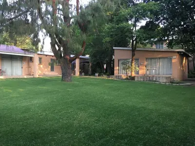 a house with a green lawn in front of it at JC Studios Ermelo in Ermelo