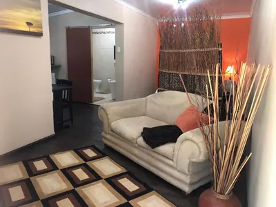 a living room with a white couch in a room at JC Studios Ermelo in Ermelo