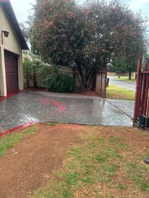 a driveway with a tree and a house at Ruros Guest House in Kempton Park