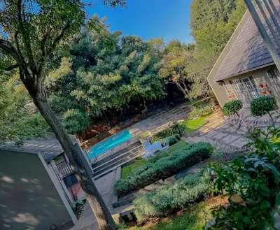 an aerial view of a backyard with a swimming pool at Amoris Guesthouse - Waterkloof ridge in Pretoria