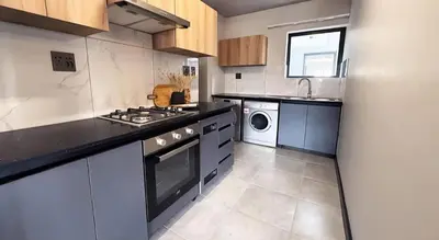 a kitchen with a stove and a sink at Elegant stay in Midrand