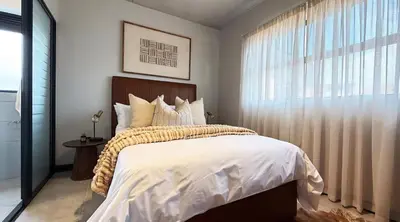 a bedroom with a large bed and a window at Elegant stay in Midrand