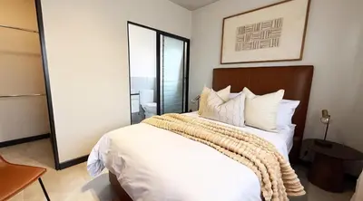 a bedroom with a large bed with white sheets and pillows at Elegant stay in Midrand