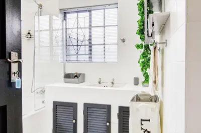 a bathroom with a sink and a mirror at Spacious Valkyrie One-bedroom in Centurion
