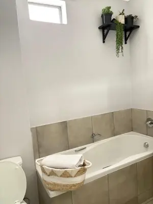a bathroom with a bath tub and a toilet at The four ones in Nelspruit