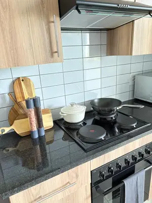 a kitchen with a stove with a pan on it at The four ones in Nelspruit