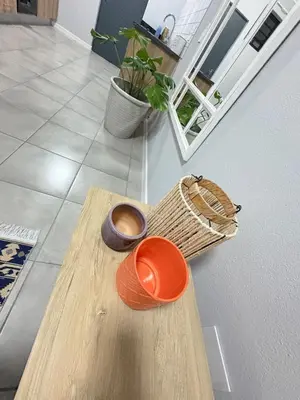 a wooden table with an orange bowl and a basket at The four ones in Nelspruit